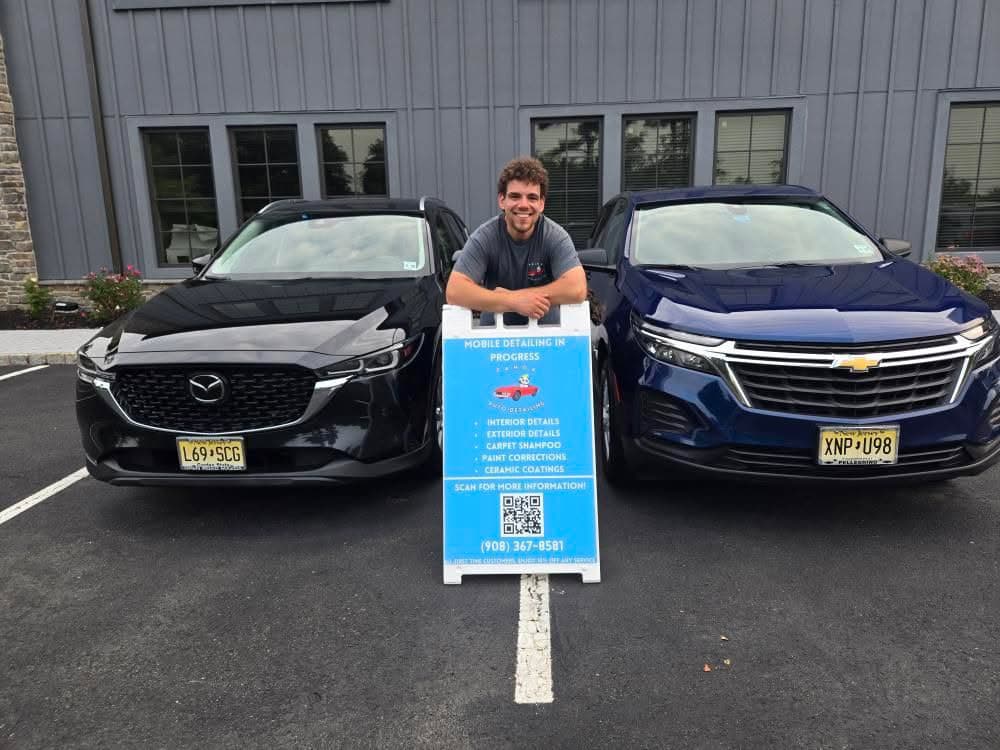 Brandon Zarin with two client vehicles and his Panda Auto Detailing mobile sign